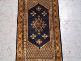 a rug on the floor with a blue and gold design