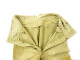 an old pair of yellow shorts with holes on the bottom of them