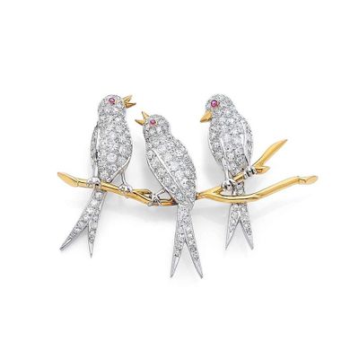 two birds perched on a branch with diamonds in their beaks