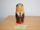 a wooden matry with a picture of a man in a suit and tie on it