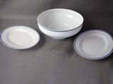 three plates and a bowl sitting on a table