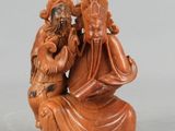 an image of a statue of a man and a woman sitting on a rock