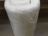 a large roll of plastic wrapped around a white table