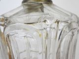 a clear glass vase with a silver lid