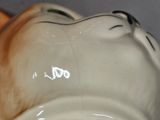 a white vase with a cat face on it