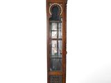 a tall wooden grandfather clock on display against a white background