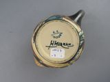 a close up of a vase with a label on it