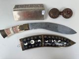 a knife, a box, and some other items on a table