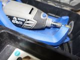an electric drill that is sitting in a case