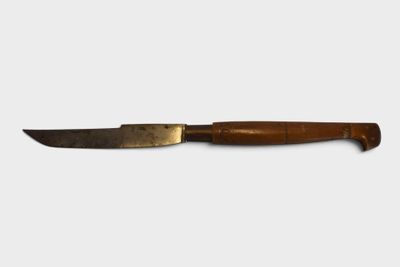 a close up of a knife with a wooden handle on a white surface