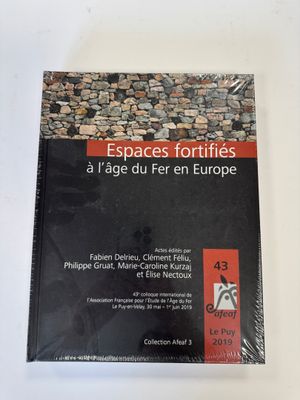a book on a white table with a black and red cover