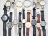 many different types of watches displayed on a white surface