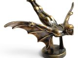 bronze figurine of a flying bat on a pedestal
