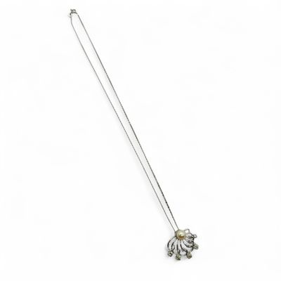 a white necklace with an elephant pendant on a chain