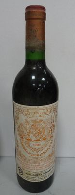 a bottle of wine sitting on a table next to a bottle of wine