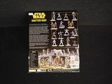 star wars action figures are displayed on a black surface