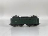 a close up of a green train car on a white surface