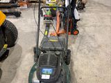a lawn mower that is sitting in the garage