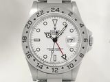 a close up of a watch on a white background with a red second hand