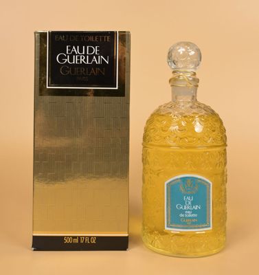 an image of a bottle of cologne next to a box of cologne