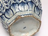a blue and white vase with a floral design on it