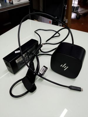 a white table with a black box and a charger on it