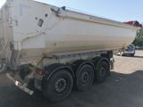 a white dump truck that is parked in a lot