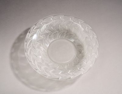 a clear glass bowl on a table with a white background