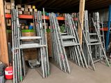 a lot of ladders that are stacked up in a room