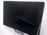 a laptop computer sitting on a stand on a white surface