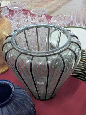 several vases and plates on a table with a red table cloth