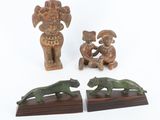 three pieces of wood with carvings of animals on them