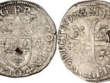 a silver coin with a shield on the front and a shield on the back