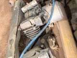 a small air compressor sitting in the corner of a room