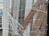 a large pile of wood and plastic wrapped around it