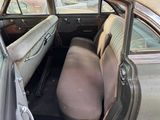 an old car that has been left in the back of the car