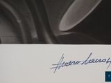 a signed picture of a man holding a knife