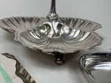 a silver plate with a spoon and spoon rest on a table