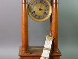 a small wooden clock with a guitar on top of it