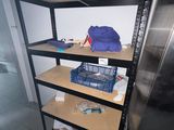 a metal shelf with a bunch of items on top of it