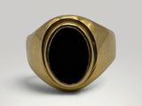 a close up of a gold ring with a black stone in it