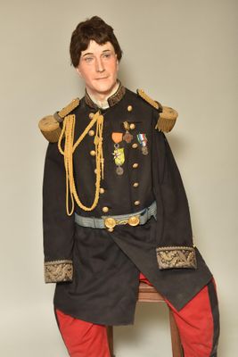 a man in a military uniform sitting on a chair