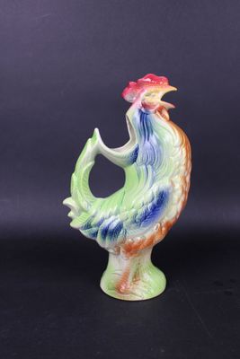 a close up of a figurine of a rooster on a black background