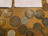 a lot of coins on the table with a note on it