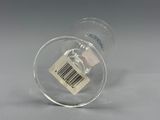 a glass with a barcode on it sitting on a table