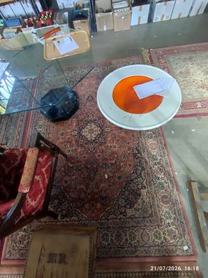 an overhead view of a living room with a rug, chair, and table