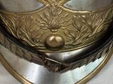 a silver and gold helmet with a cross on it