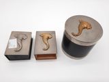 three metal items including a box with a seahorse on it