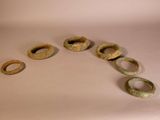 five rings that are sitting on a white surface