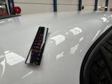 a remote control sitting on the hood of a car